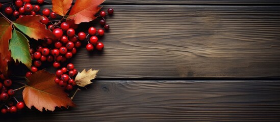 A Thanksgiving concept featuring autumn berries and leaves on a wooden background creating a serene autumnal atmosphere Copy space image
