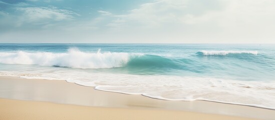 A tropical beach with blurred waves and sand in the foreground Offers plenty of copy space for your image