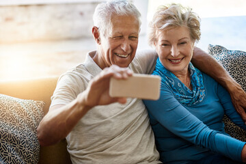 Senior, happy couple and relax with selfie on sofa for memory, photography or picture at home....