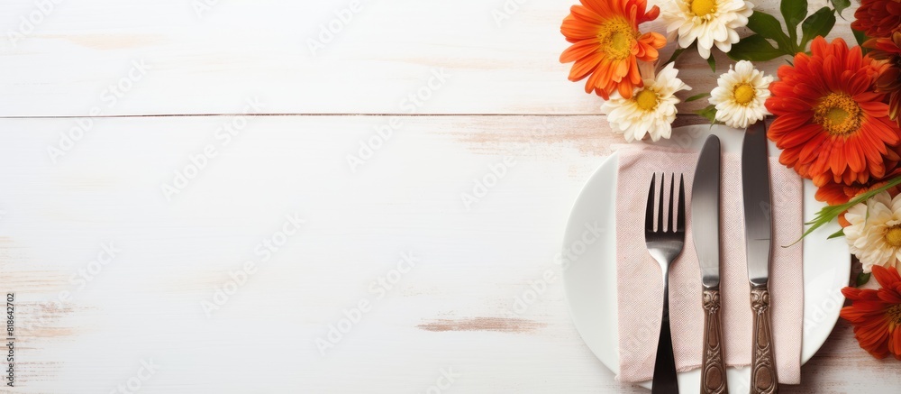 Poster A light background with cutlery a napkin and flowers is available for text placement a copy space image