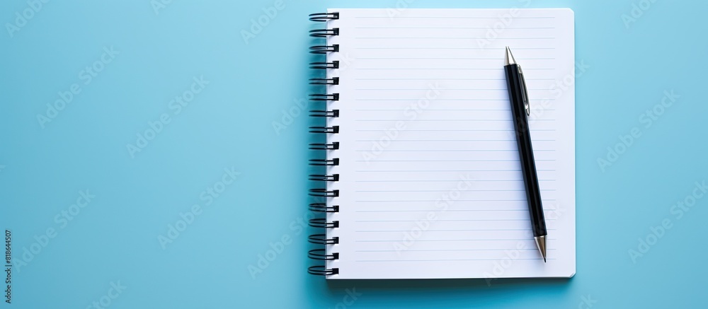 Leinwandbilder a top view copy space image of a notebook and pen placed on a blue background