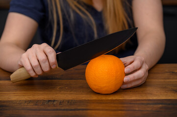 Obierać pomarańcze dużym nożem kuchennym, słodki naturalny zdrowy deser 