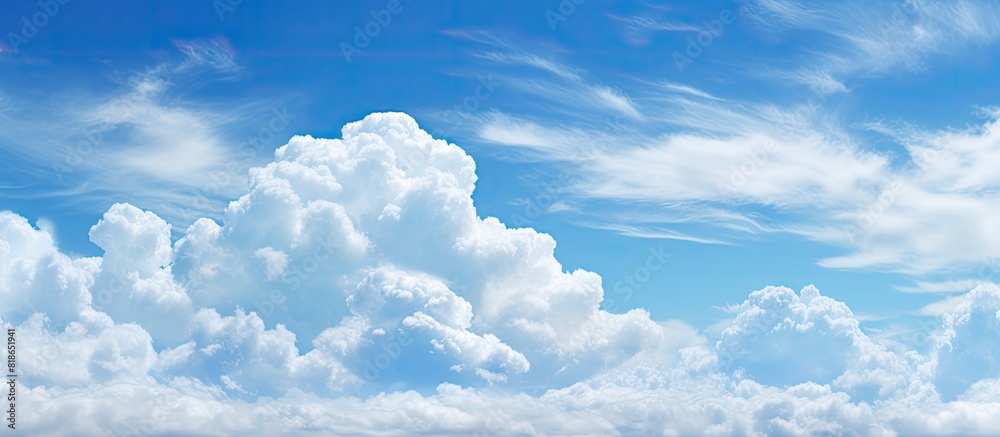 Poster During the daytime the sky is adorned with serene and tranquil puffy clouds against a backdrop of a vibrant blue color Available as a copy space image