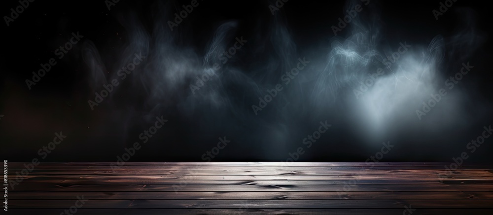Poster a dark background highlights an empty wooden table where smoke elegantly rises the perfect copy spac