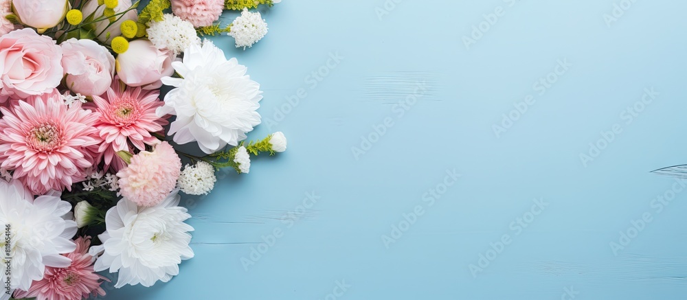 Poster on a blue table there is a keypad pink adhesive notes a pen and a bunch of white flowers creating a 