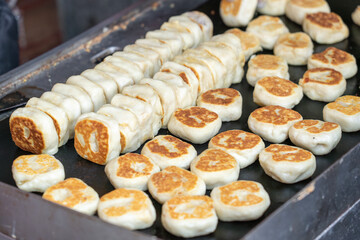 Fresh meat mooncakes on frying pan