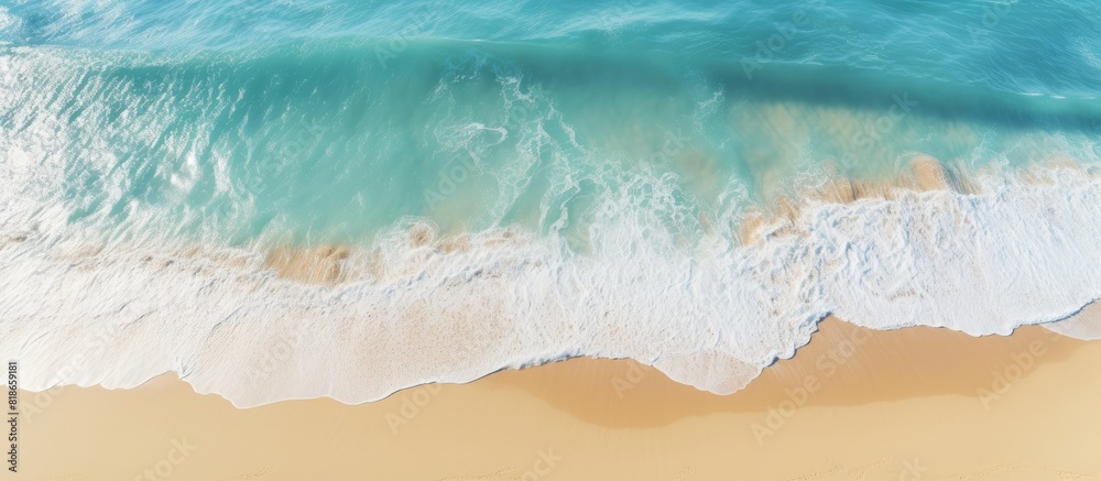 Poster a picturesque view of a sandy beach from above featuring light blue translucent waves and sun rays t