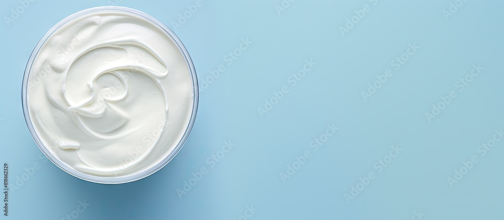 Poster A delicious organic yogurt is displayed on a light blue surface with a top down perspective providing room for text in the image. with copy space image. Place for adding text or design