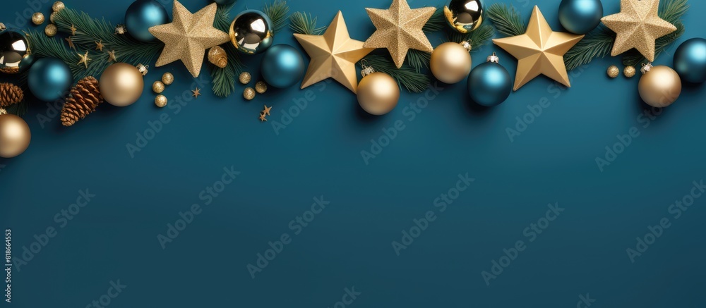 Leinwandbilder a christmas frame consisting of fir branches golden stars and balls on a blue background the image i