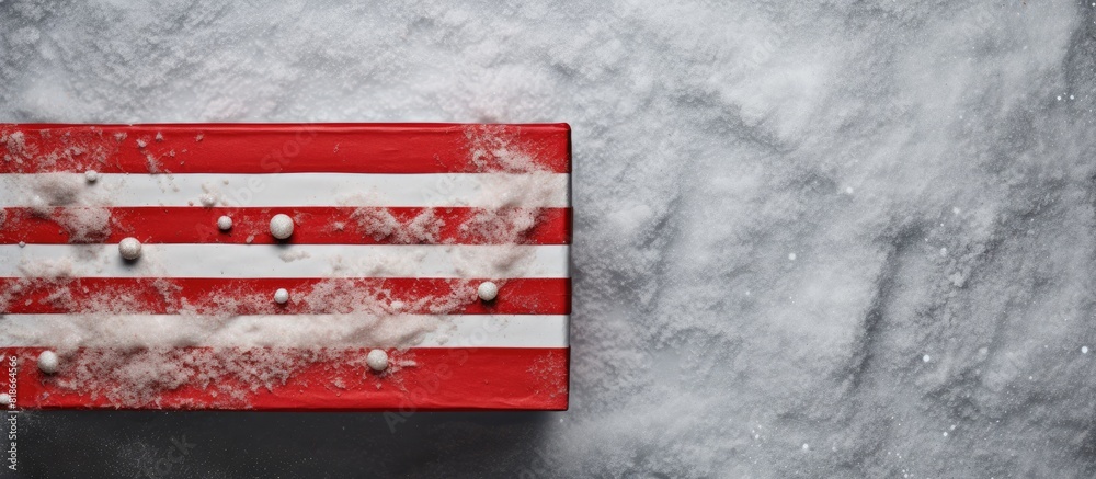 Poster A handmade box with red striped paper adorned with fir and snow represents the concept of Christmas and New Year Seen from above on a grey background there is ample copy space in the image