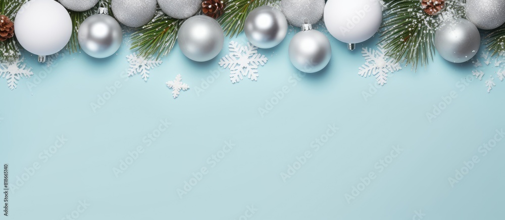 Poster there is a flat lay image featuring white and silver christmas balls along with pine branches on a p