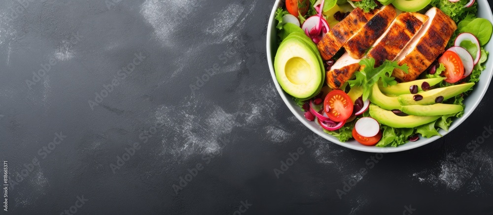 Poster Aerial shot of a white bowl filled with a delicious salad The salad includes grilled chicken fillet and is placed on a light slate stone or concrete background There is also enough empty space for ad