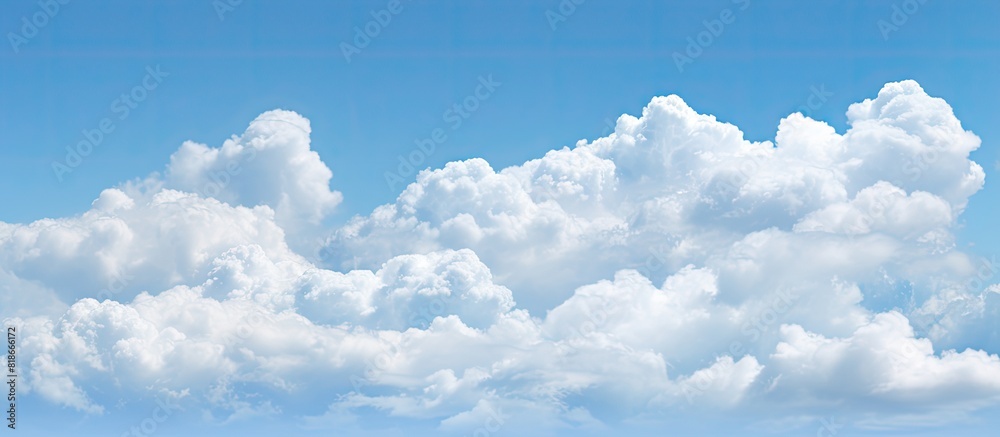 Poster a nature background featuring puffy white clouds against a clear blue sky with copy space image avai