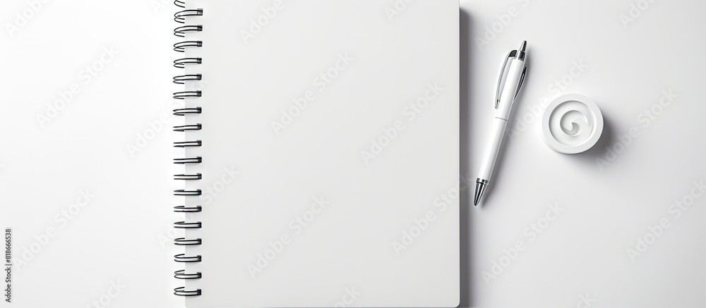 Aufkleber a blank white notebook with a closed spiral cover and a pencil seen from a top down perspective on a