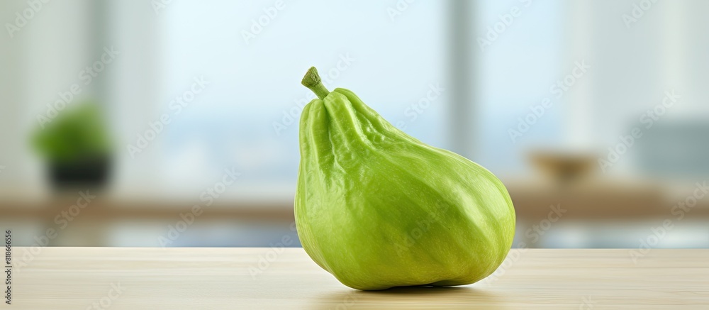 Aufkleber close up of a vibrant green chayote on a table providing ample copy space for text