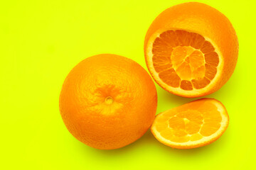 Juicy sliced oranges on yellow lemon. Ready to eat,drink and cook