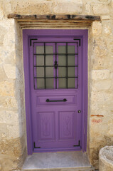 Old Greek era Purple painted wooden door in Alacati, Turkey