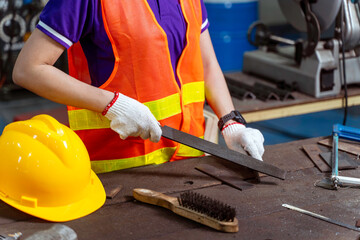 Closeup and crop Construction worker wearing vest working in industrial workshop.