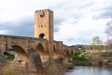 Detail shot of the impressive medieval stone bridge in the tourist town of Frías in the province of Burgos on a sunny day