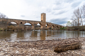 Impressive panoramic view of the medieval stone bridge of the tourist town of Frías in the province of Burgos on a cloudy day