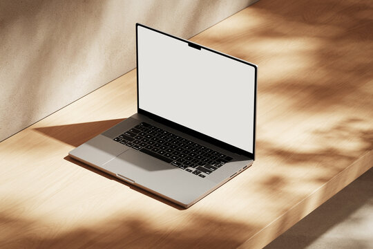 Apple MacBook Pro on the wooden desk on a plaster background