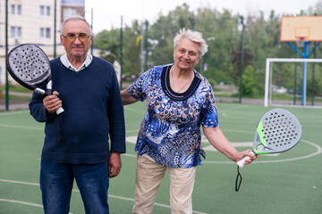senior man playing paddle tennis a 