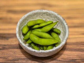 fresh green peas.Edamame in a white ceramic bowl on a wooden table.Beans are high in protein.