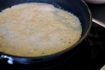 Close up of a lentils pancake in a pan