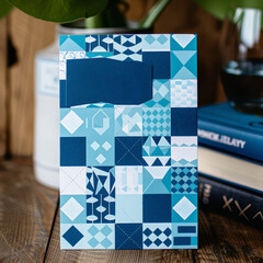 Modern Father's Day card mockup with geometric patterns in various shades of blue and bold white font