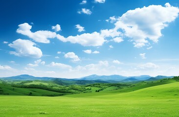 Fototapeta premium Green grassy hills with blue sky and mountains landscape background