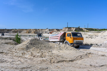 Excavators, dump trucks working and extracting the chalk in a quarry in the village of Melovye Gorki, West Kazakhstan region.