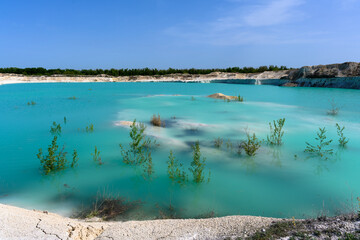 The blue lake, layered mountains, hills of limestone, limestone quarry in the village of West...