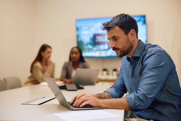 Male entrepreneur working laptop at start up office.