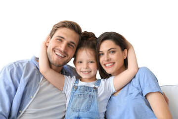 Positive friendly young parents with smiling little daughter sitting on sofa together while...
