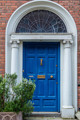 Classic image of a traditional painted door in Dublin, Ireland. The vibrant colors and unique architectural details capture the charm and character of Dublin's historic homes.