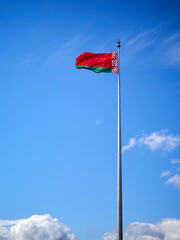 National flag of the Republic of Belarus against the blue sky