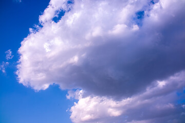 Clouds against the blue sky close-up. Changes in weather during the rainy season. Thunderclouds,...