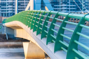 A green metal bridge with a green railing