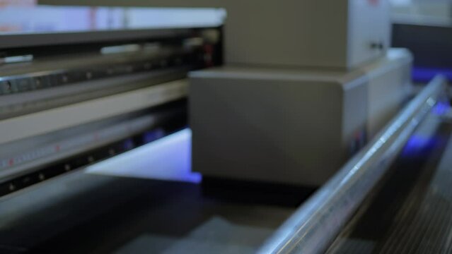 Large format colorful printing - UV digital flatbed printer during work - selective focus