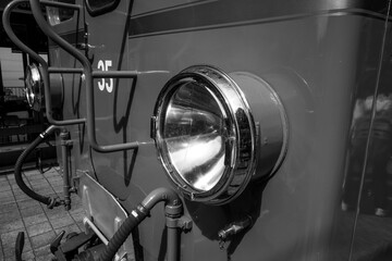 the front lights on a train engine at night time on the tracks