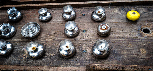 metal fittings are sitting on the wood table next to a yellow toy