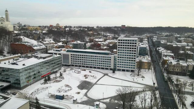 Drone footage of the urban buildings in Unity Square on a cloudy winter day in Kaunas, Lithuania