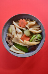 Delicious Chinese style calamari with vegetables on na bed of brown jasmine rice.