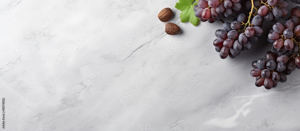 Poster A top view of wine and grapes on a grey marble background with ample copy space for additional elements or text