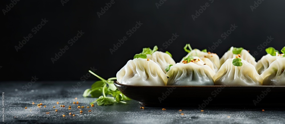Poster side view close up of dumplings seasoned with pepper salt herbs and microgreens served on a gray con