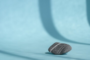 striped pebble on blue background