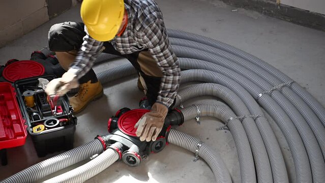 HVAC Technician Working on Modern Air Duct Pipe