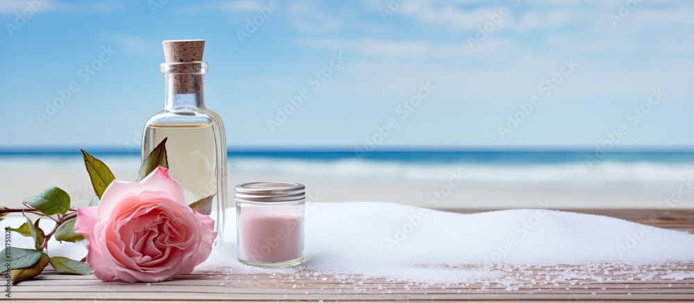 Poster a table displaying a bottle of rose essential oil alongside sea salt with plenty of copy space for a