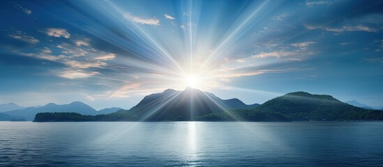 Copy space image of sunbeams shining down on a picturesque island in the middle of the ocean
