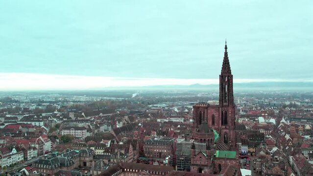 Drone footage of Strasbourg Cathedral against cloudy dusk sky in Strasbourg, Alsace, France